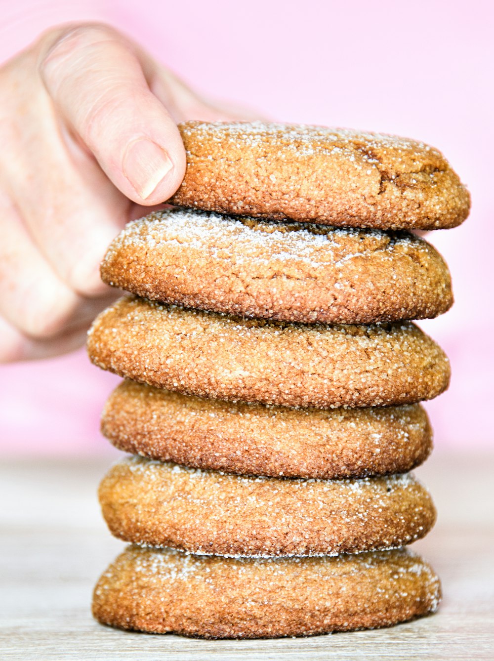 a stack of cookies with powdered sugar on top