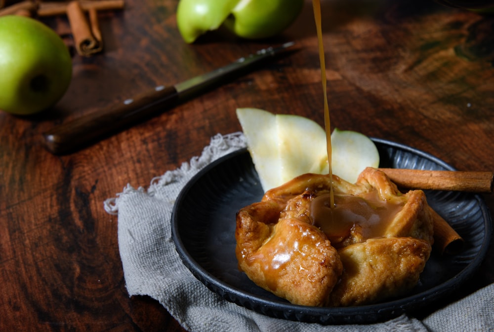 a plate of food with apples and cinnamon on a table