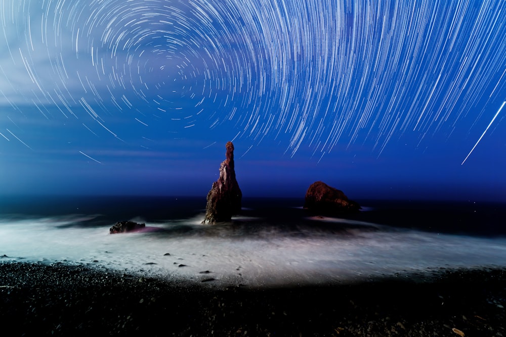 a long exposure of a star trail over the ocean