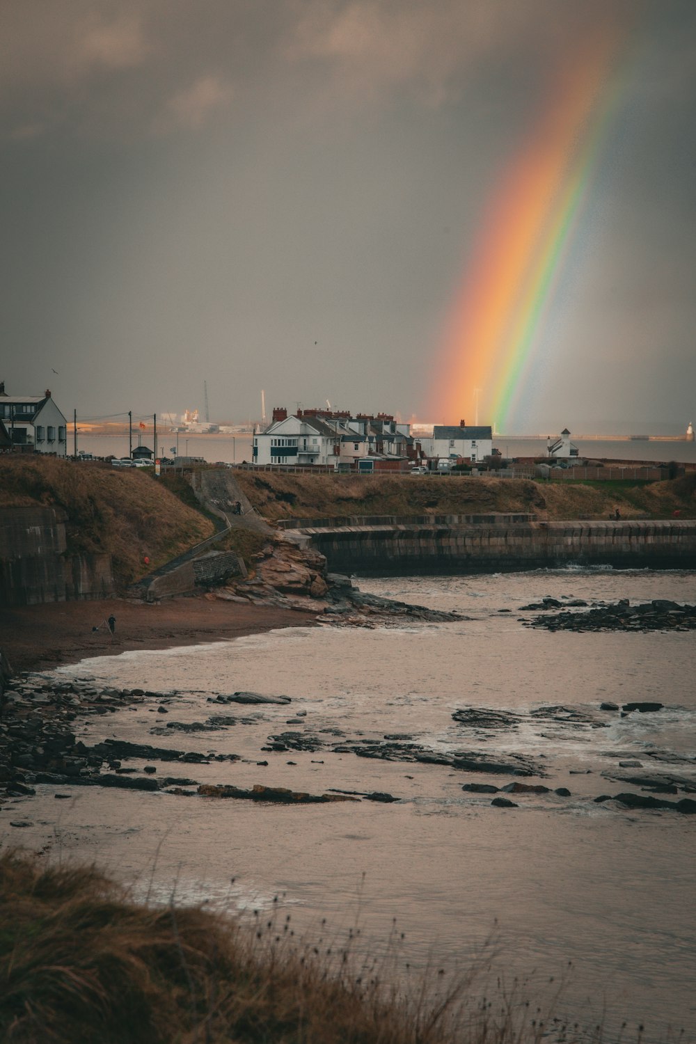 a rainbow in the sky over a body of water