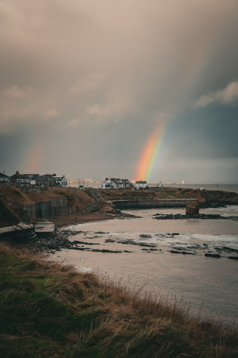 a rainbow in the sky over a body of water