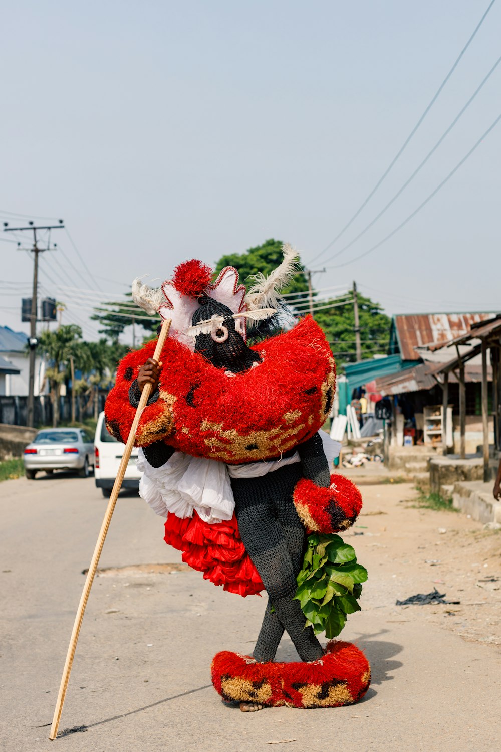 a person in a costume holding a stick