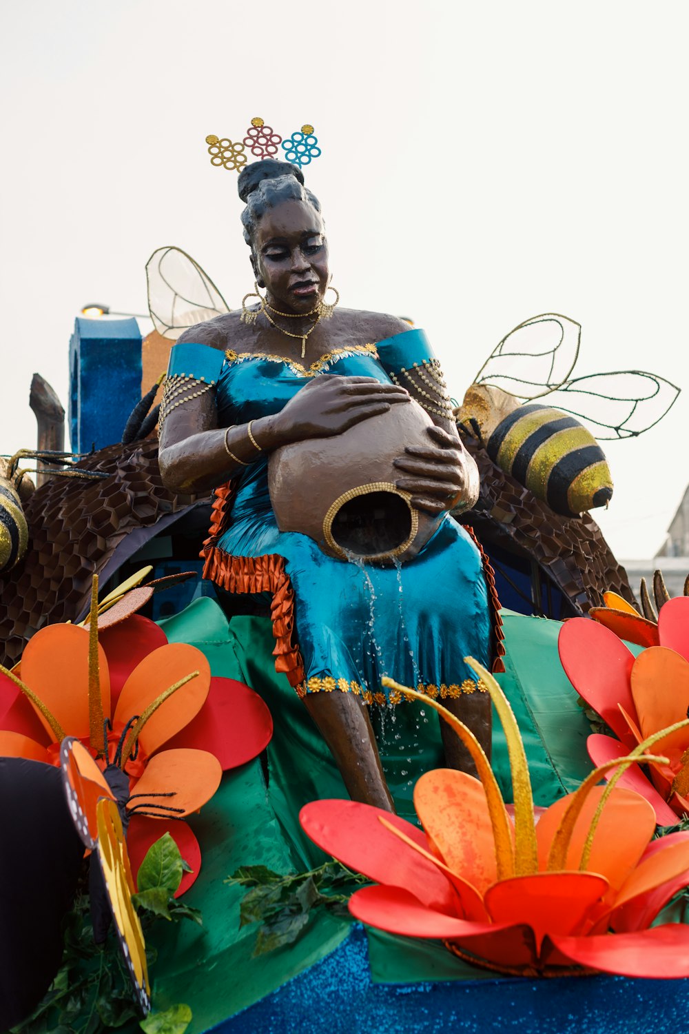 a statue of a woman sitting on top of a float