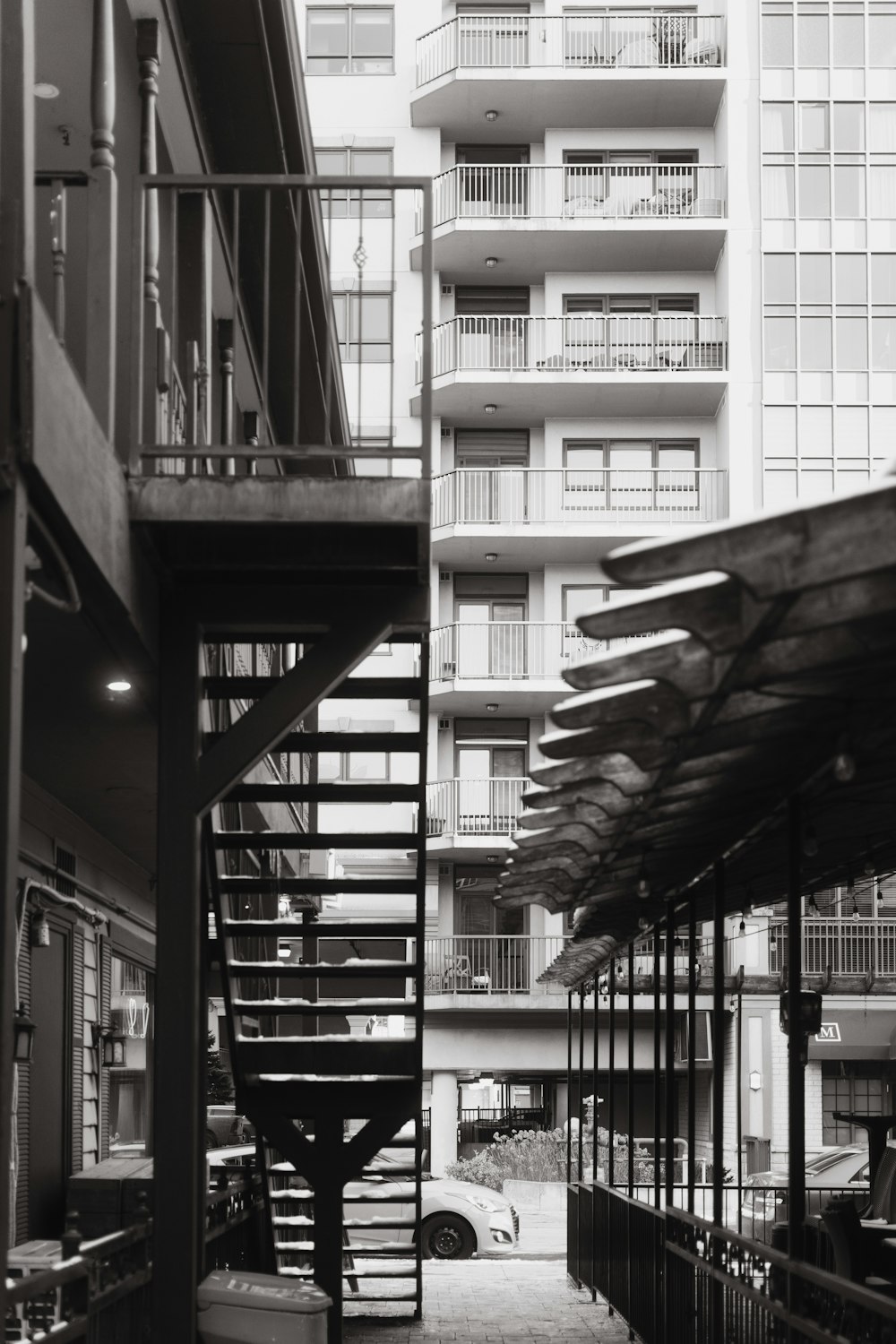 a black and white photo of a spiral staircase