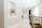 A bright, freshly painted modern living room with soft grey walls and crisp white trim, showcasing a flawless finish.