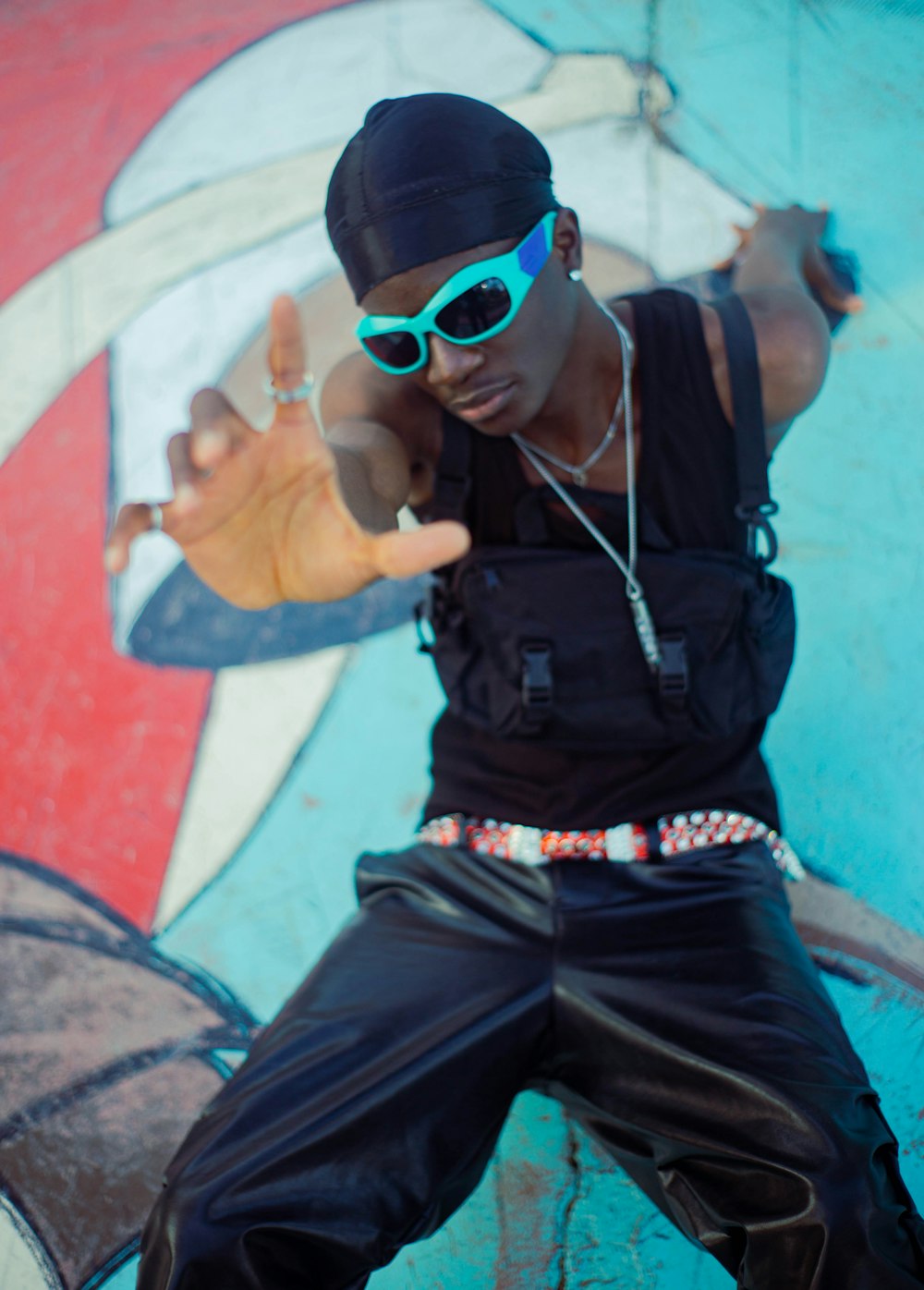 a man in a black shirt and sunglasses posing for a picture