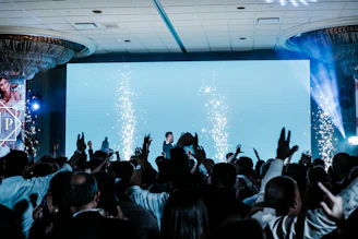 a crowd of people standing around a stage