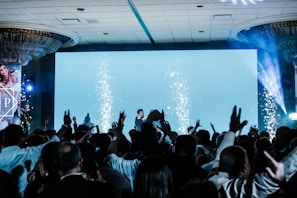 a crowd of people standing around a stage