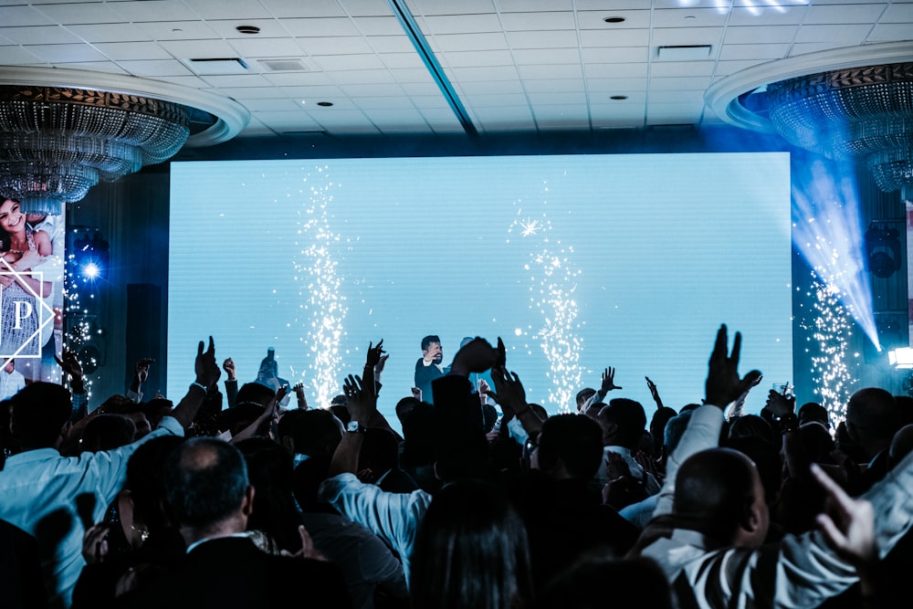 a crowd of people standing around a stage