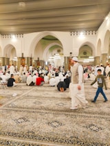 A community center bustling with people of all ages participating in learning and prayer.
