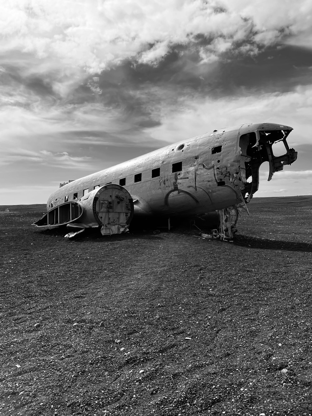 a large airplane sitting on top of a dry grass field