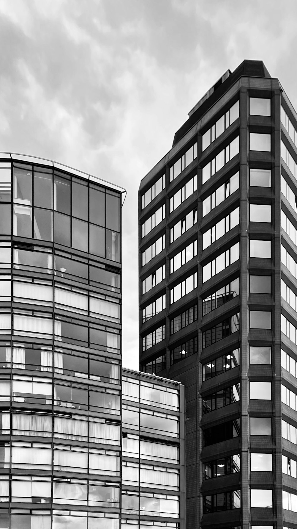 a black and white photo of two tall buildings