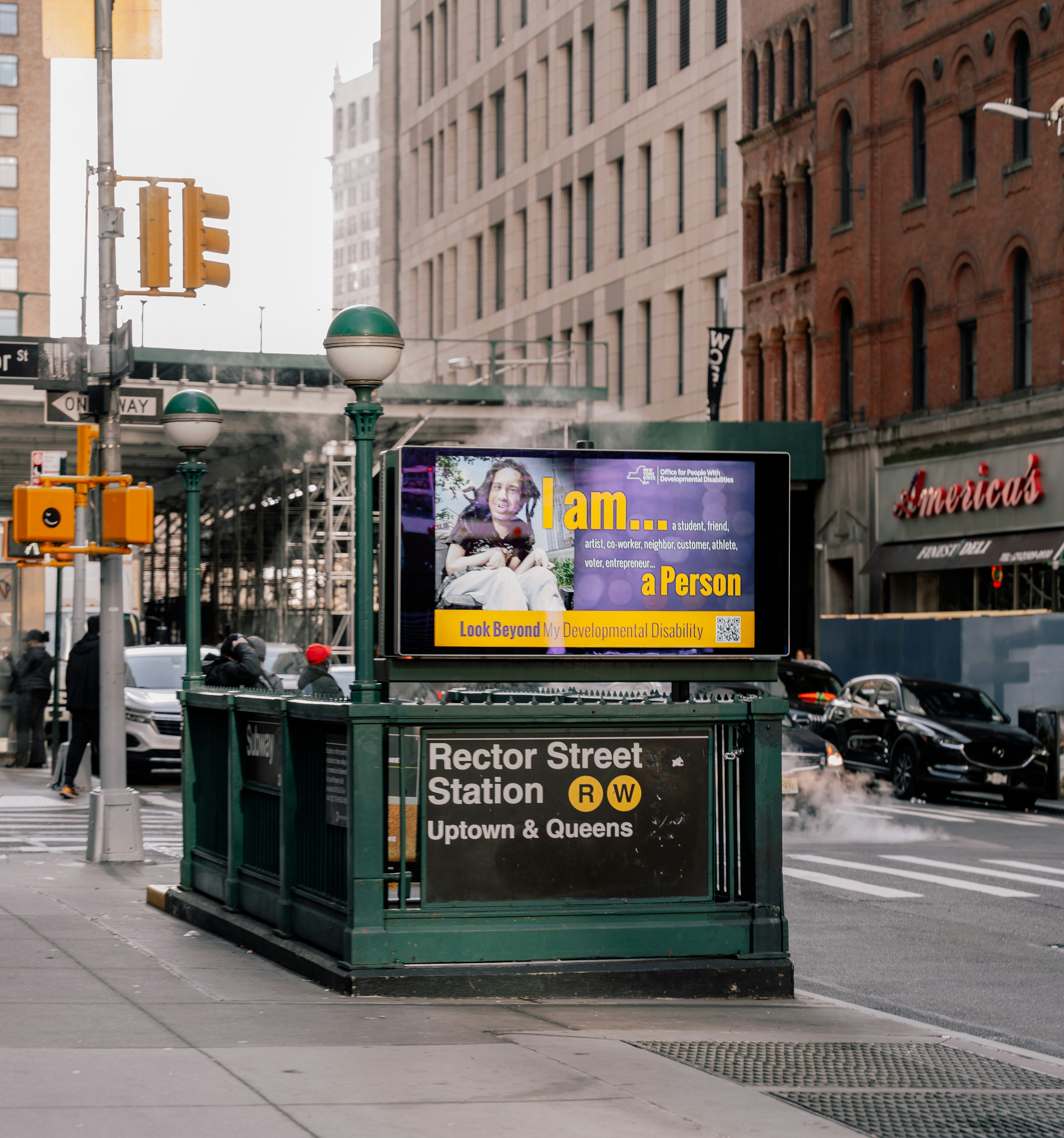 A billboard advertisement on the side of a city street