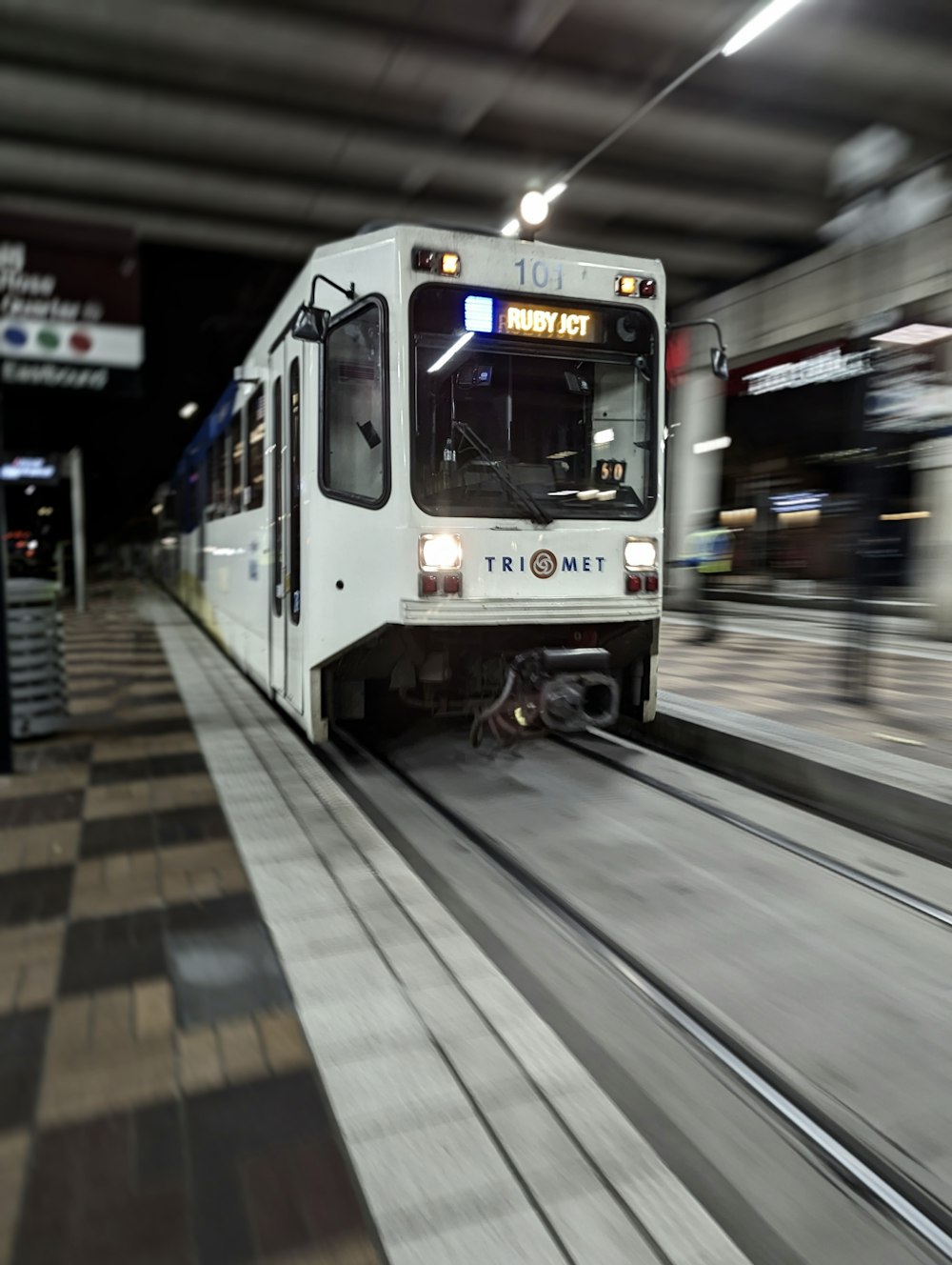 a white train traveling through a train station