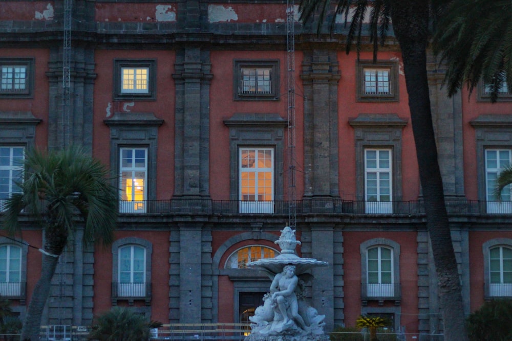 a large building with a fountain in front of it