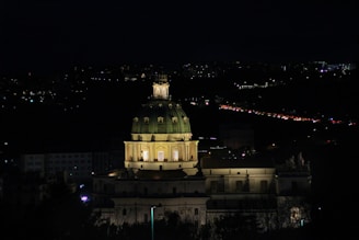 Nighttime shot of a dome illuminated warmly from within.