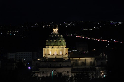 Nighttime shot of a dome illuminated warmly from within.