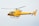 A bright yellow helicopter is flying in the sky, showcasing sleek aerodynamic design with visible registration marks. The helicopter has a single main rotor and a tail rotor.