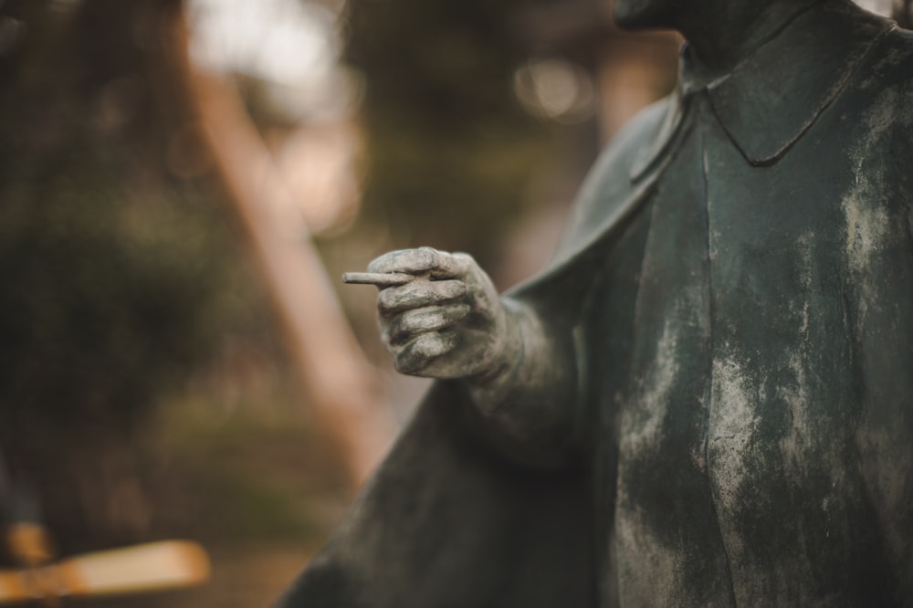 a statue of a man holding a cell phone