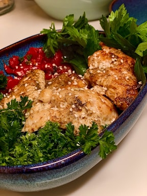 A beautifully arranged plate of grilled chicken with vibrant vegetables.