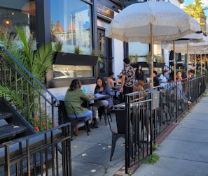 Outdoor seating area at Domuss with customers enjoying their meals in a relaxed atmosphere