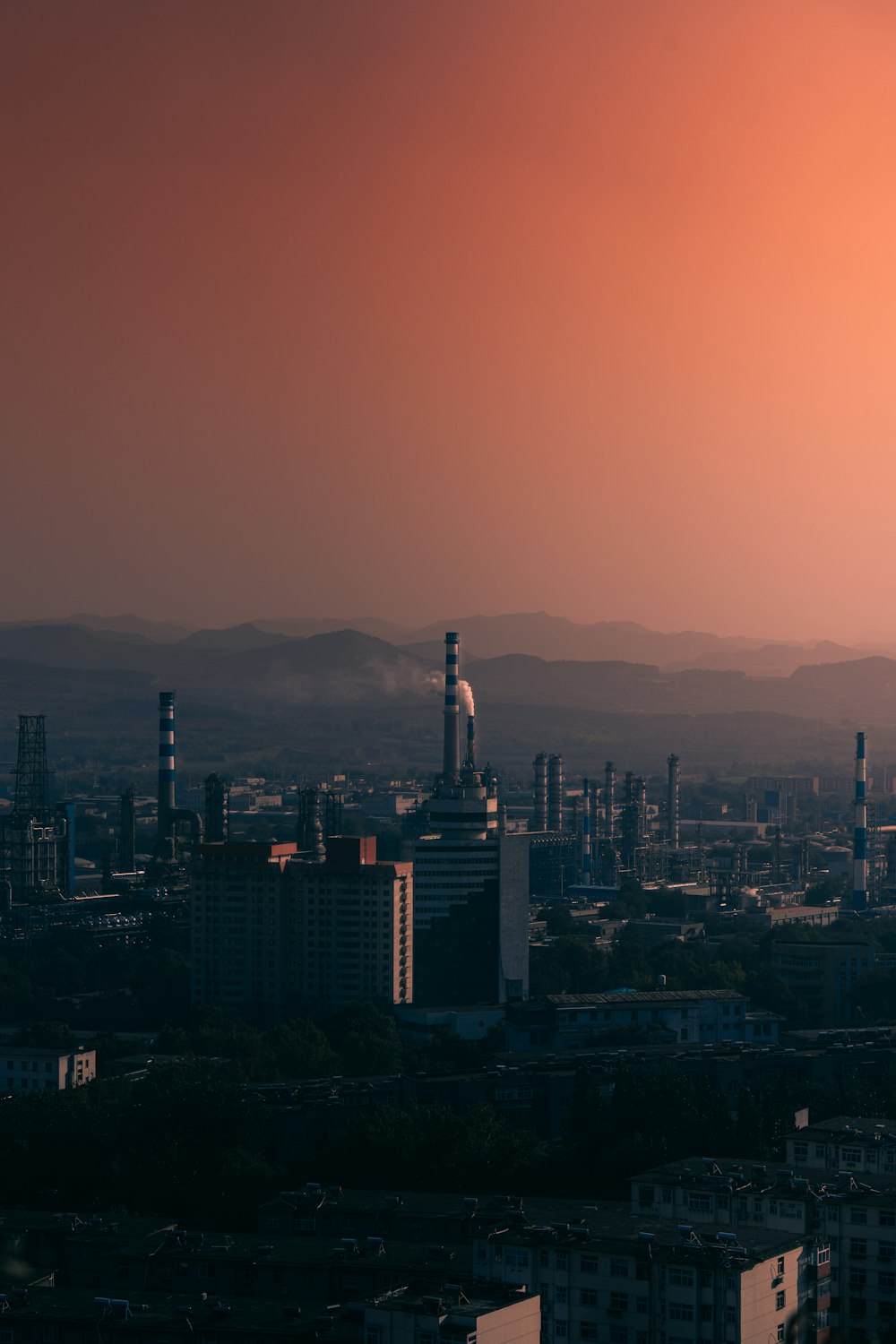 a view of a city at sunset with a red sky