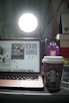 A cozy workspace with a laptop displaying social media icons and a cup of coffee nearby.