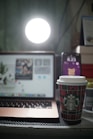 A cozy workspace with a laptop, coffee cup, and affiliate marketing notes scattered around.