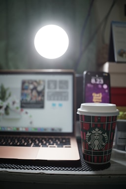 A cozy workspace with a laptop and coffee cup.