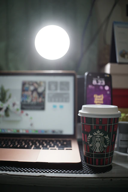 A cozy workspace with a laptop, notebook, and a cup of coffee inviting users to get in touch.