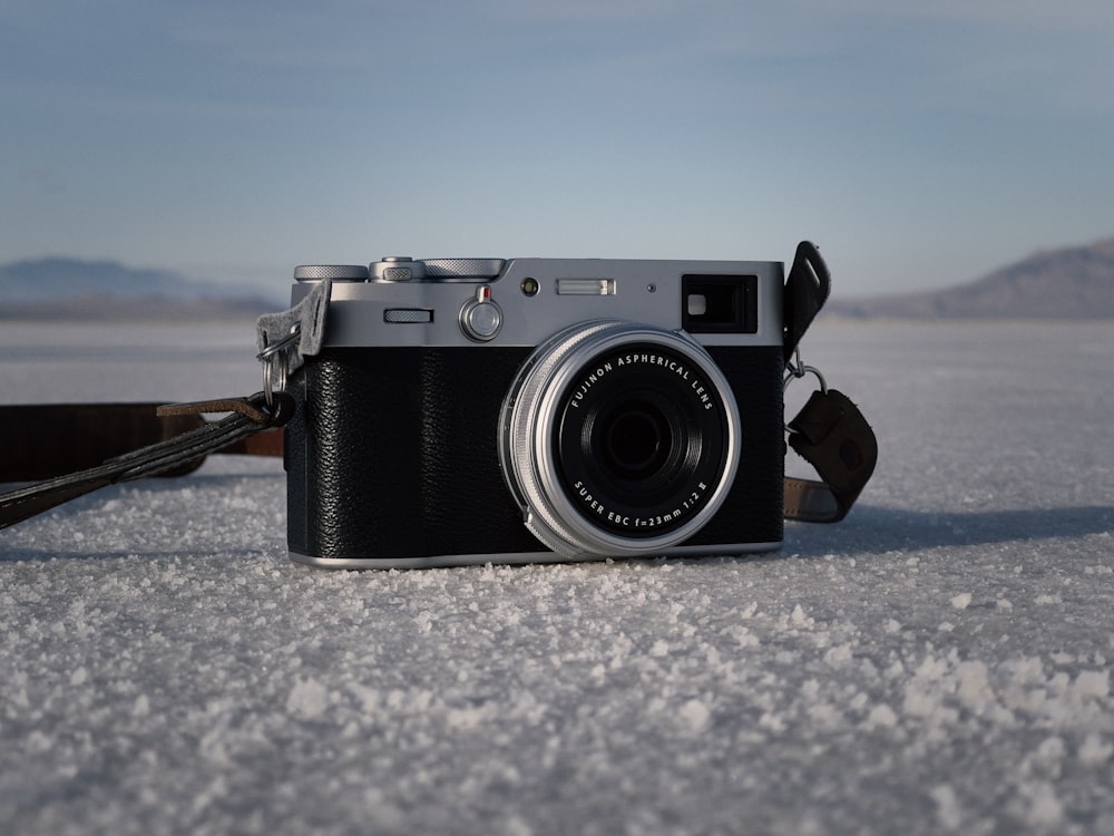 a camera sitting on top of a snow covered ground