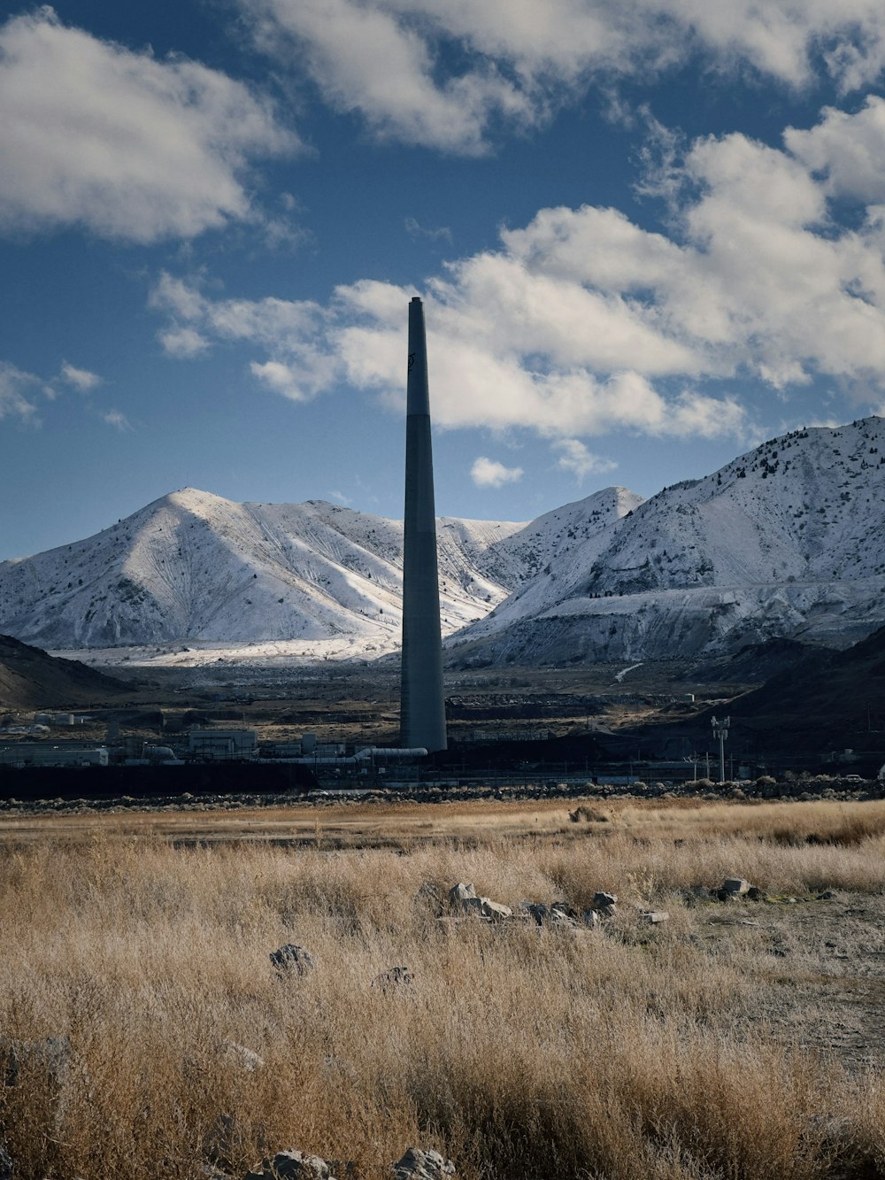 a tall tower sitting in the middle of a field