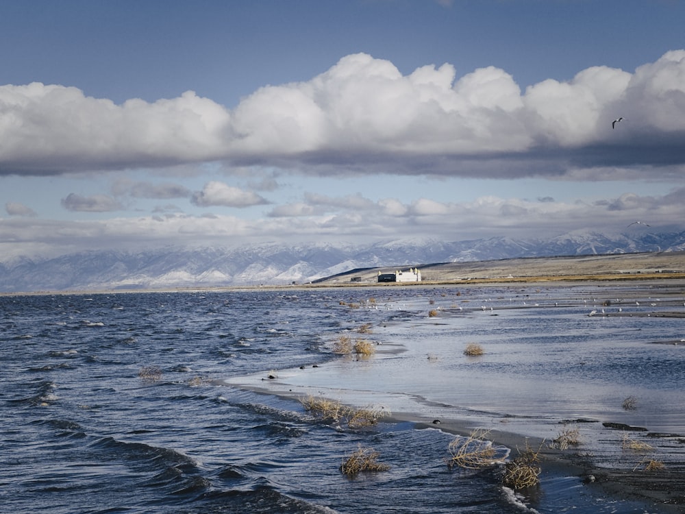 a large body of water with mountains in the background