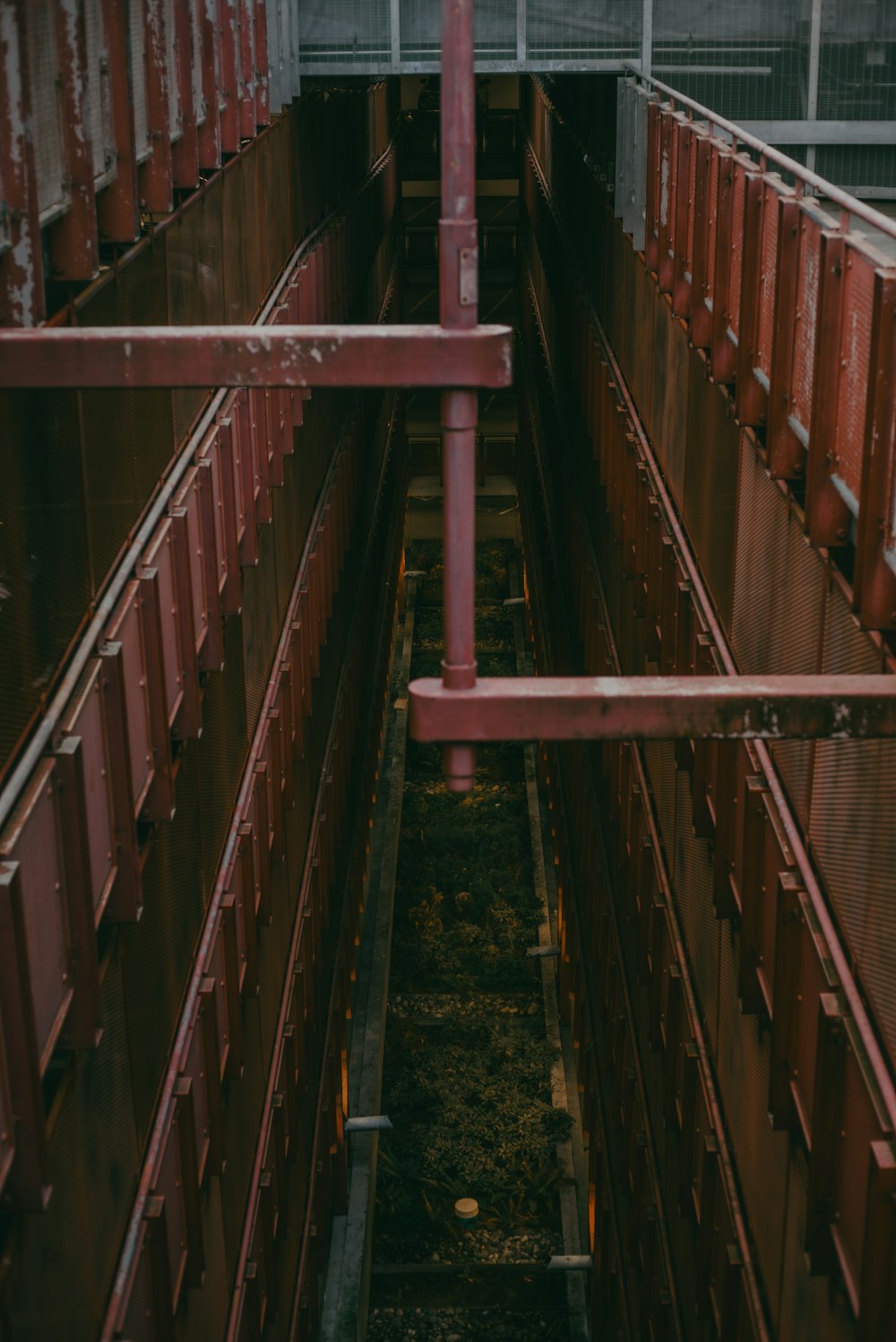 a train traveling through a train yard next to a tall building