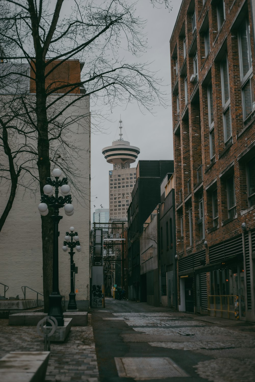 a city street with a tall tower in the background