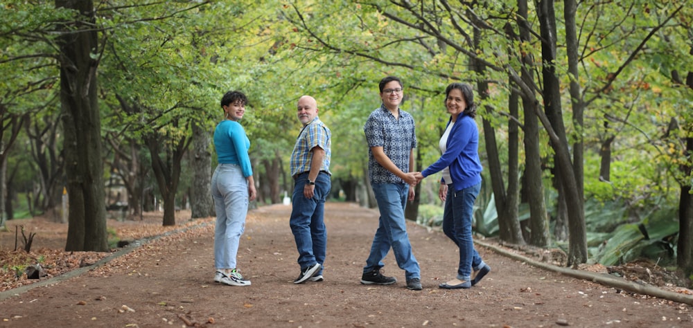 a group of people standing in the middle of a forest