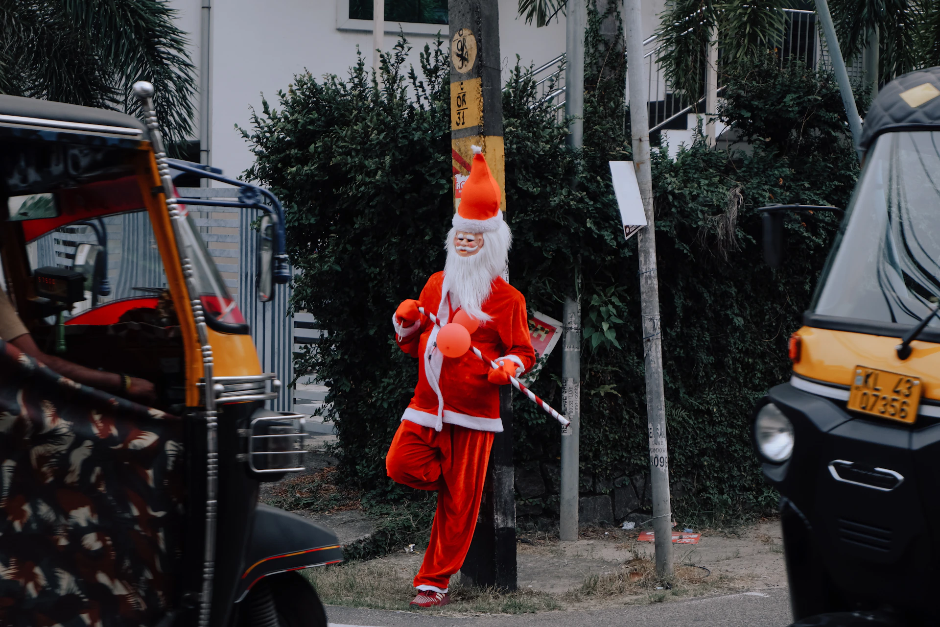 a man dressed as santa claus walking down the street