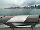 Tourists enjoying a waterfront attraction with a QR code sign nearby.