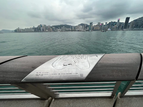 Tourists enjoying a waterfront attraction with a QR code sign nearby.