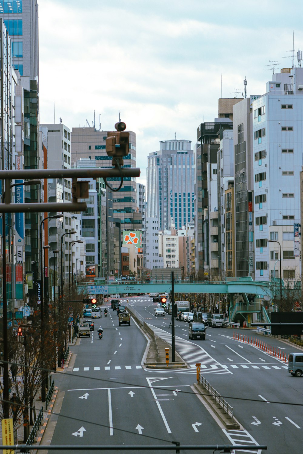 a city street filled with lots of traffic next to tall buildings