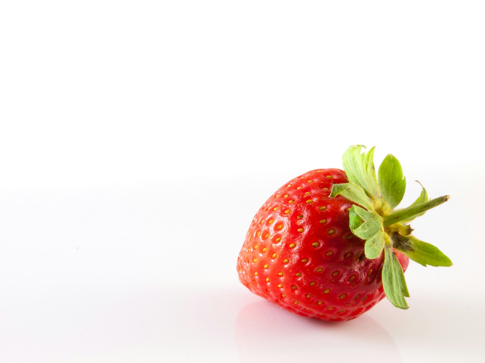 a close up of a strawberry on a white background