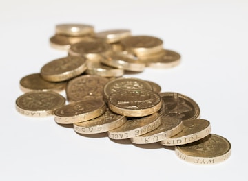 a pile of coins sitting on top of a white table