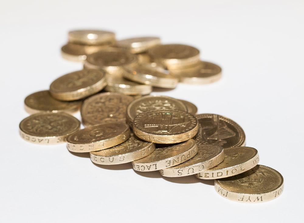 a pile of coins sitting on top of a white table