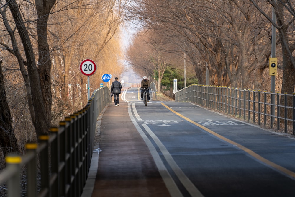 a couple of people riding bikes down a street