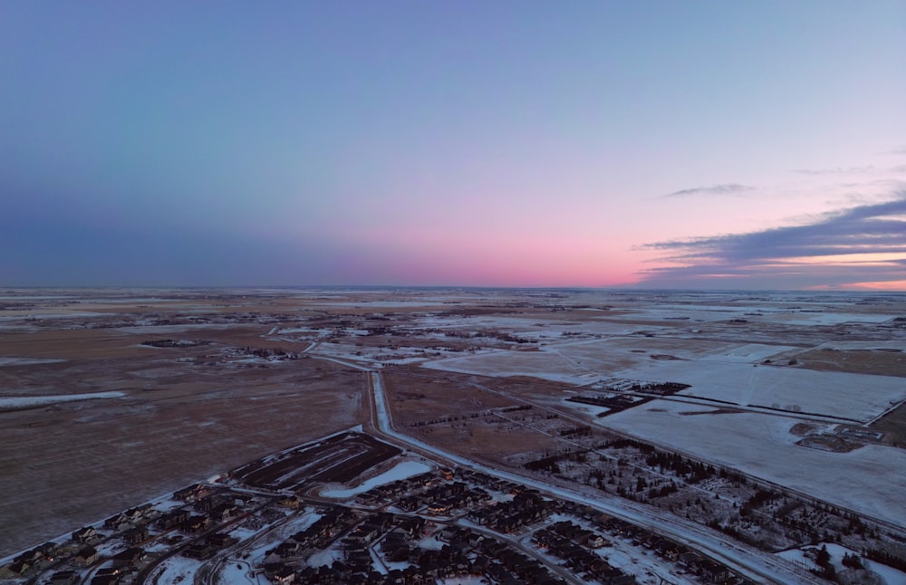 an aerial view of a rural area with snow on the ground