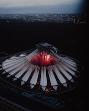 A sleek dome structure shielding a cityscape under a stormy sky with lightning in the distance.