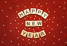 happy new year spelled with scrabbles on a red background