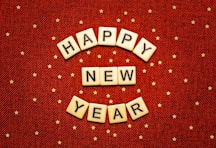 happy new year spelled with scrabbles on a red background
