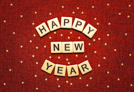happy new year spelled with scrabbles on a red background