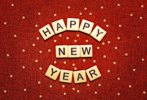 happy new year spelled with scrabbles on a red background